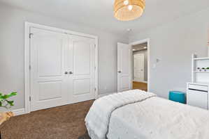 Bedroom with carpet floors and a closet