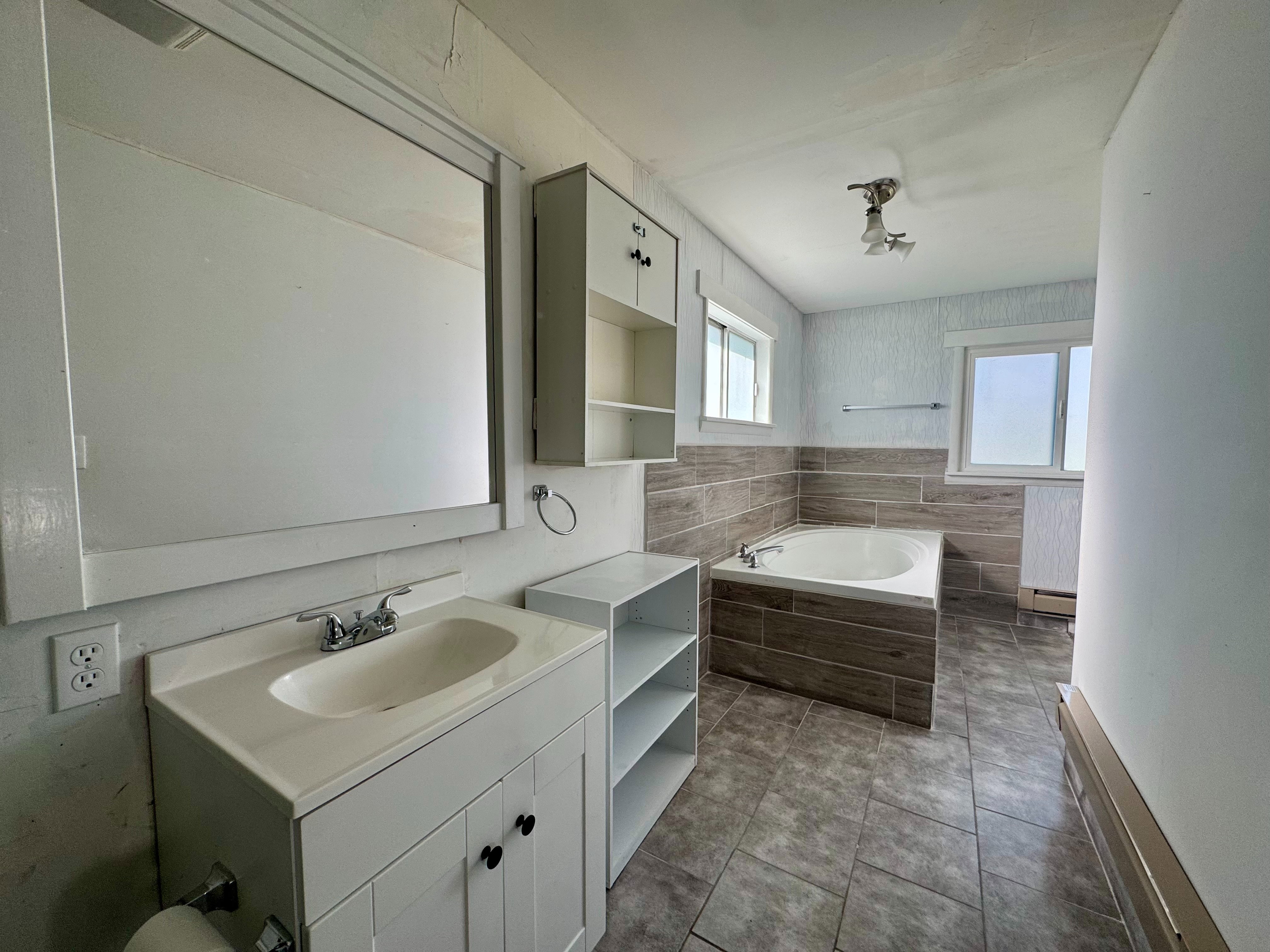 Primary bathroom with a tub and shower.