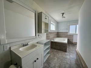 Primary bathroom with a tub and shower.