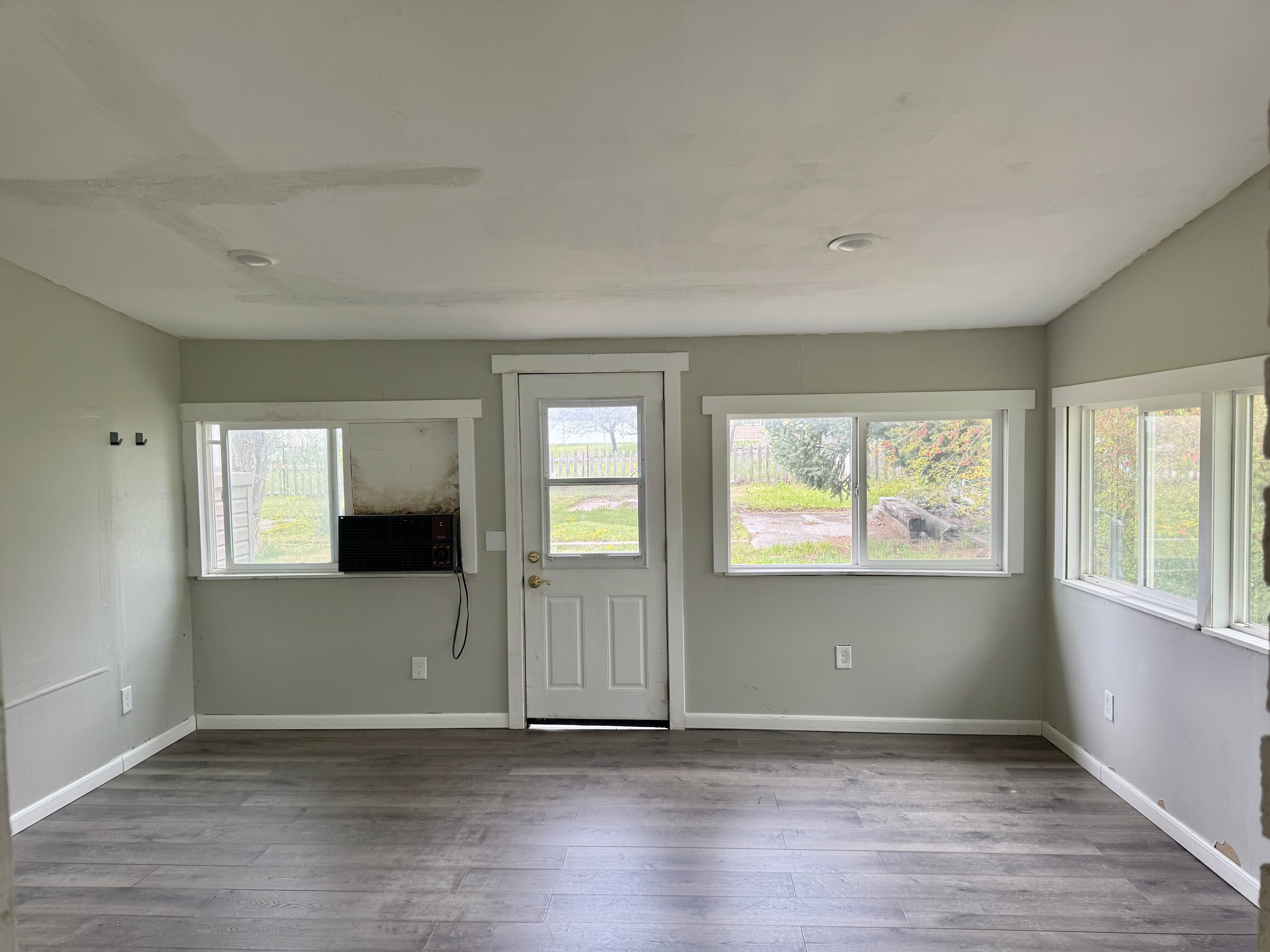 Doorway to outside featuring wood-style floors and cooling unit