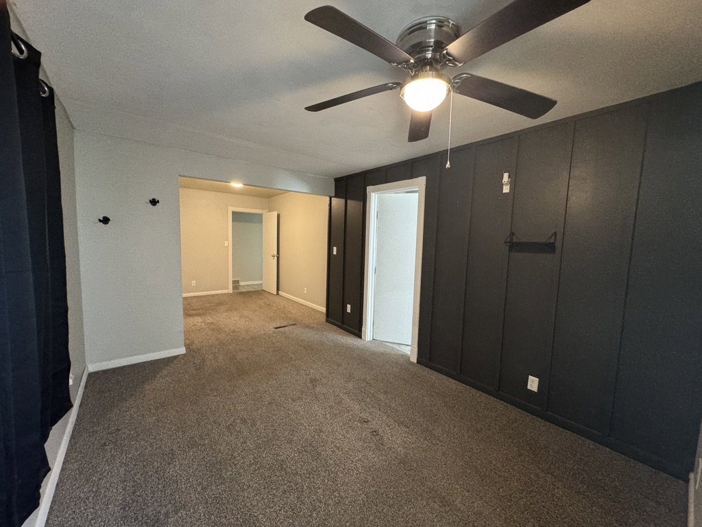 Primary bedroom featuring carpet and a ceiling fan
