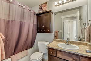 Bathroom with vanity and shower / bath combination with curtain