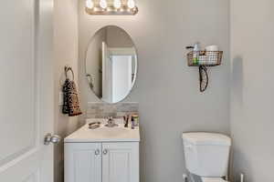 Bathroom with backsplash and vanity