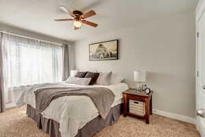 Bedroom featuring light colored carpet and ceiling fan
