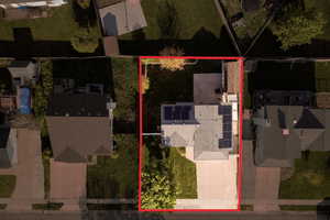 Aerial view of residential area with property boundaries highlighted