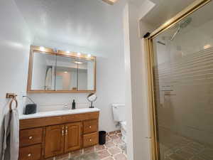 Bathroom featuring vanity, and a stall shower