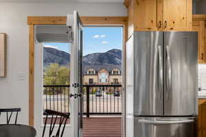 Kitchen with freestanding refrigerator, a mountain view, and light wood finish cabinets