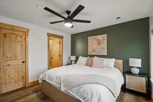 Bedroom featuring dark wood finished floors and a ceiling fan