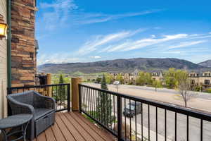 Balcony featuring a residential view and a mountain view