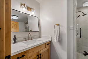 Bathroom with vanity and a stall shower