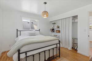 Bedroom with light wood-style floors and baseboards