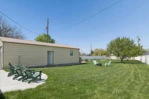 Fenced backyard featuring a fire pit