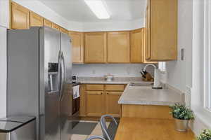 Kitchen featuring stainless steel appliances, light countertops, and light tile patterned flooring