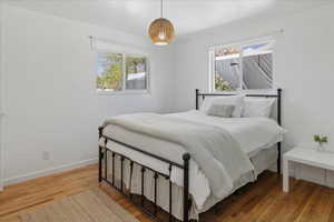 Bedroom with wood finished floors and baseboards
