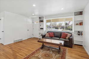 Sitting room featuring light wood-style flooring and recessed lighting