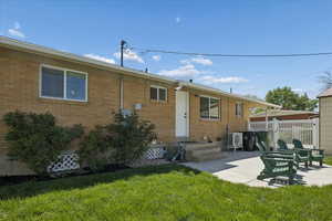 Rear view of property featuring a patio area and brick siding