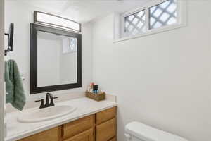Bathroom featuring vanity and a textured ceiling