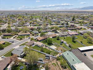 Aerial view of property and surrounding area with nearby suburban area