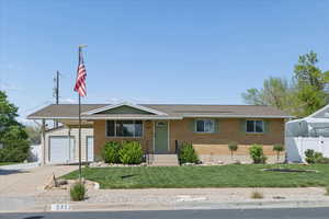 Ranch-style house featuring brick siding and driveway