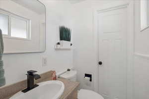 Bathroom featuring vanity and toilet