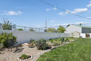 Fenced backyard with a storage shed