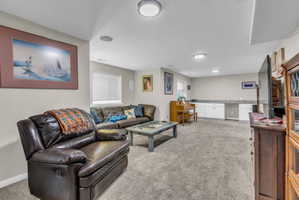Living area featuring light colored carpet