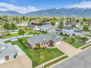 Aerial perspective of suburban area featuring a mountain backdrop