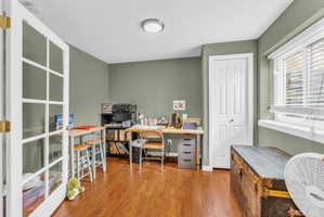 Home office featuring light wood-style floors and baseboards