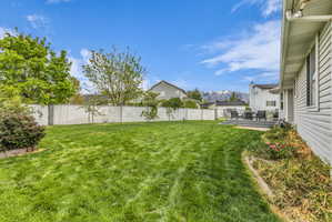 Fenced backyard featuring a deck with mountain view