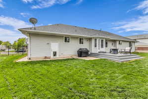 Back of property with a patio and roof with shingles