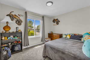 Bedroom featuring light carpet and baseboards