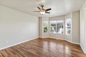Primary Bedroom featuring a ceiling fan and dark wood-type flooring