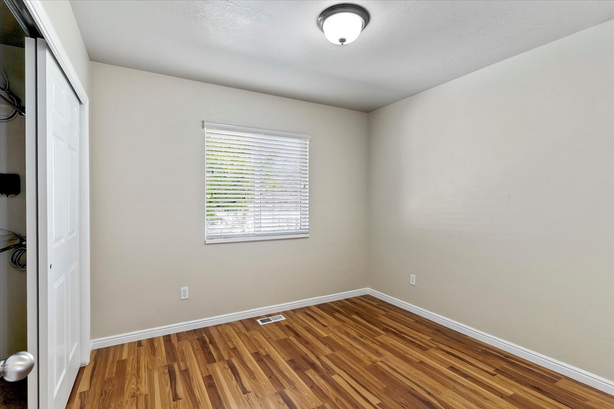 Bedroom with a closet and wood finished floors
