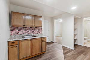 2nd Kitchen featuring dark wood-type flooring, wood finish cabinetry, decorative backsplash, and recessed lighting