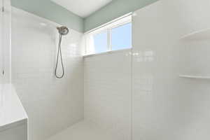 Bathroom featuring a tile shower