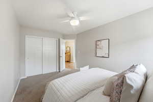 Bedroom featuring a closet, carpet flooring, and a ceiling fan