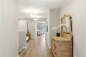 Hall featuring baseboards and light wood-type flooring