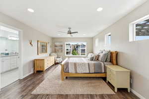 Bedroom featuring dark wood-type flooring, ceiling fan, ensuite bathroom, and recessed lighting