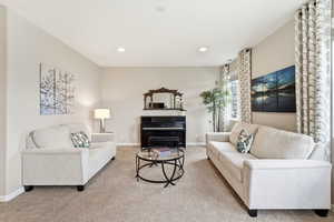 Living room featuring light colored carpet and recessed lighting