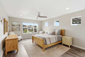 Bedroom featuring wood finished floors, ceiling fan, and recessed lighting