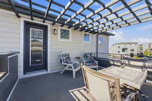View of patio with outdoor dining area and a pergola
