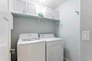 Laundry room featuring washer and dryer and cabinet space