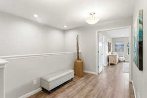 Living area featuring light wood-type flooring and recessed lighting