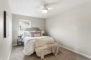 Bedroom with a ceiling fan and carpet floors