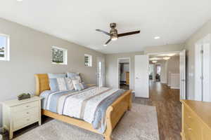 Bedroom with dark wood-style flooring, a spacious closet, recessed lighting, and ceiling fan