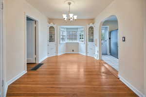 Dining area. Hardwood flooring and arched walkway/openings
