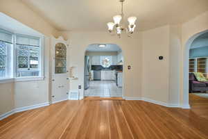 Dining area. Features built-in corner cabinets, and hardwood flooring