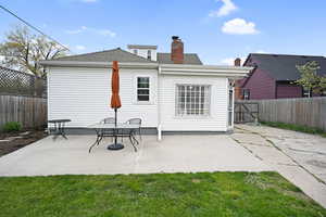 Back of property featuring a fenced backyard, a patio area
