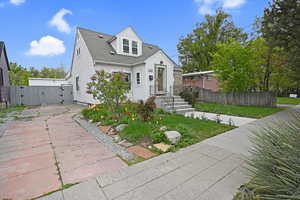 View of front of home with a gate, and driveway