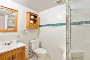 Full bathroom featuring a stall shower and vanity